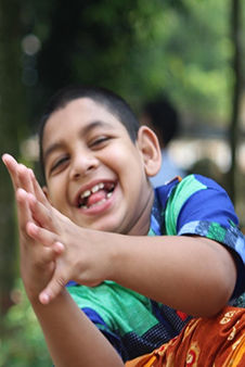 Bangladeshi boy with cerebral palsy with his mother